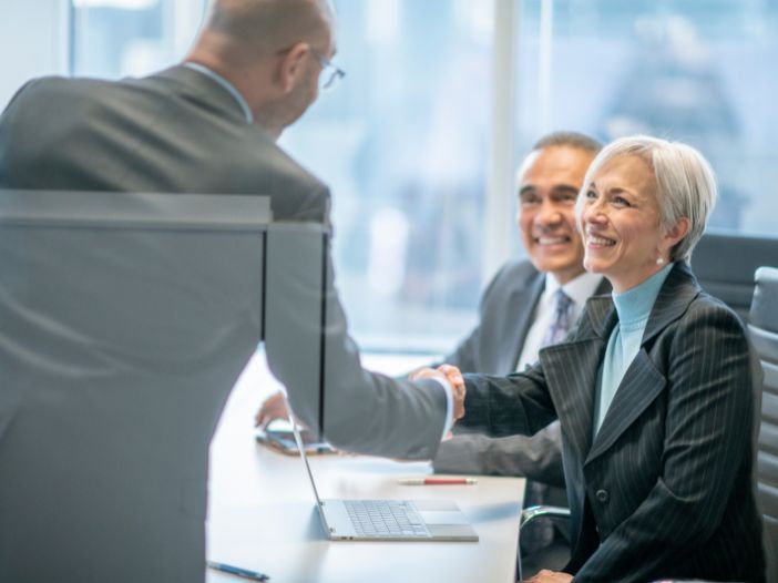 A financial advisor meeting with clients