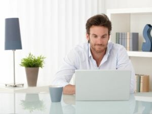 Guy on laptop searching keyword examples for his business