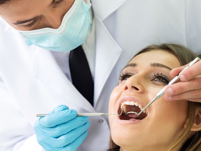 Dentist cleaning a lady's teeth