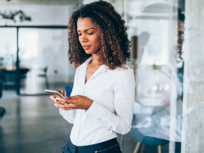 Professional woman reading cpa post on social media from her phone