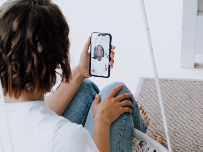 Two ladies Facetiming each other on iPhones