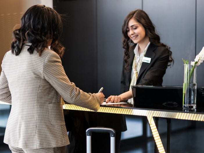 businesswoman checking into a hotel