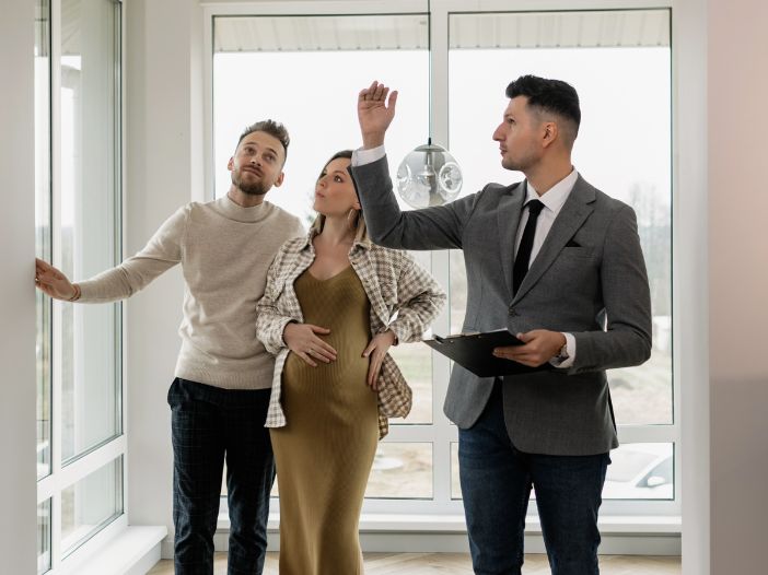 real estate agent showing a condo to a couple