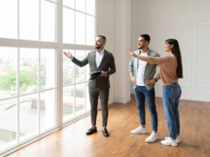 real estate agent showing couple the view from the window